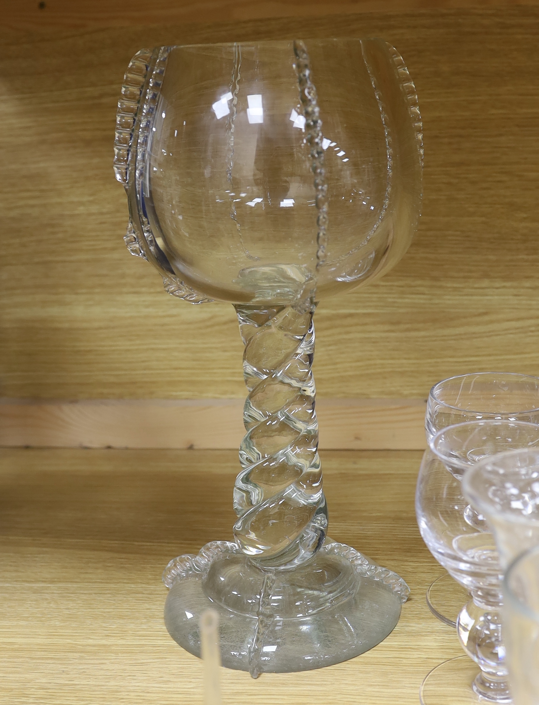 A large glass centrepiece, a teardrop trumpet shaped vase and a collection of 19th and 20th century wine and other drinking glasses